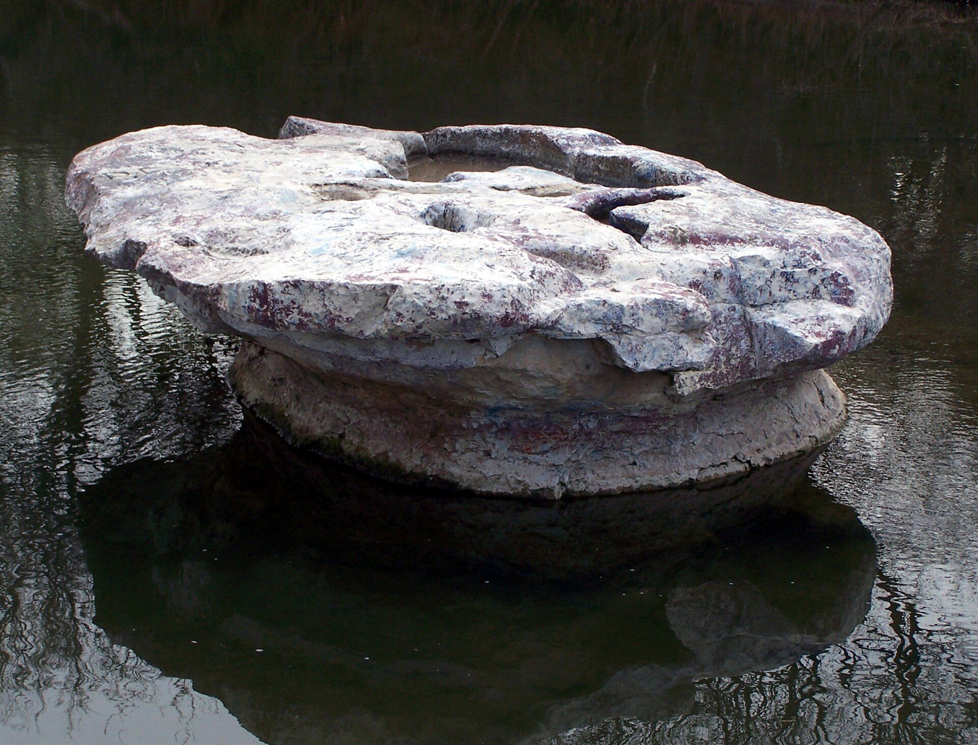 The round, anvil-shaped limestone rock in Brushy Creek that gave Round Rock, Texas its name