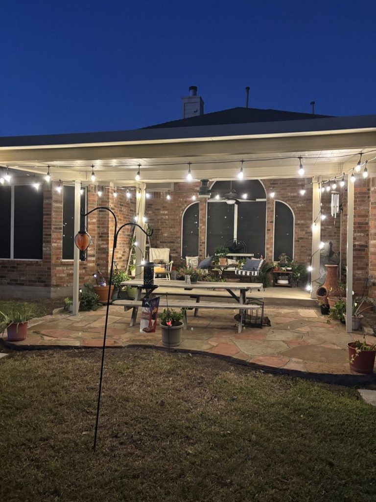 Covered patio with bistro string lights over outdoor seating