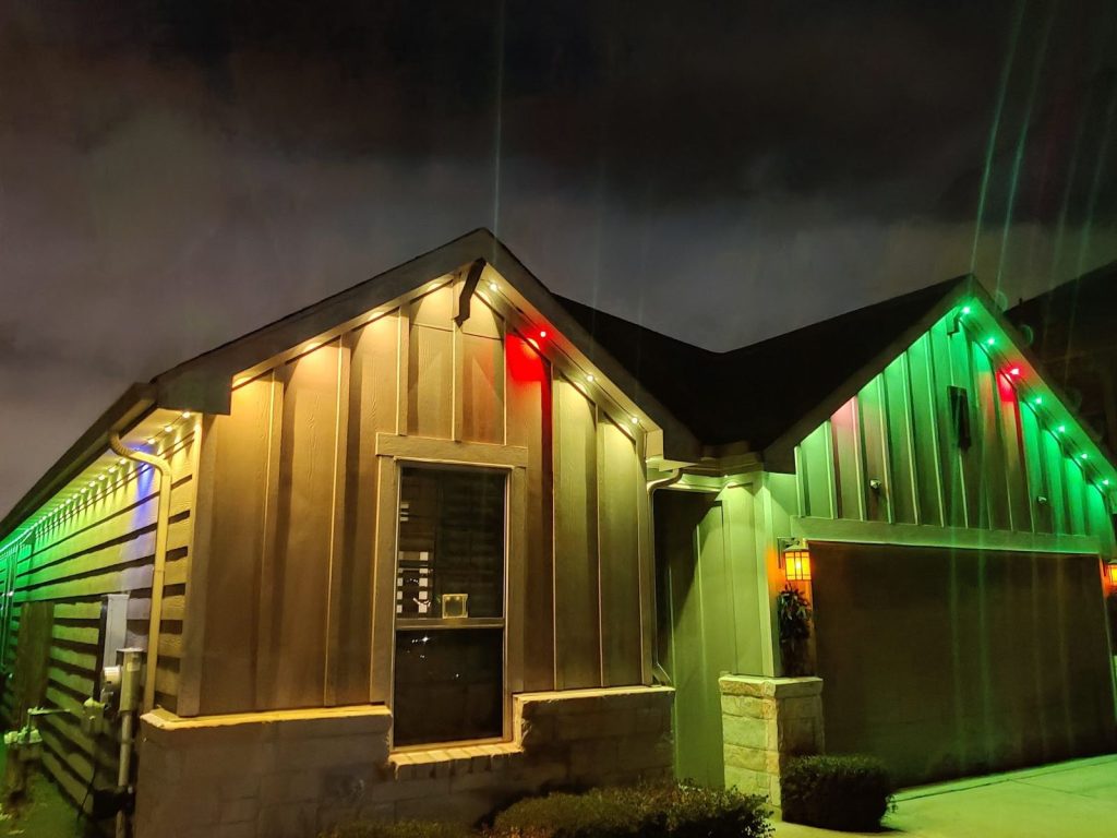 Gabled home with permanent lights in red, green and warm white