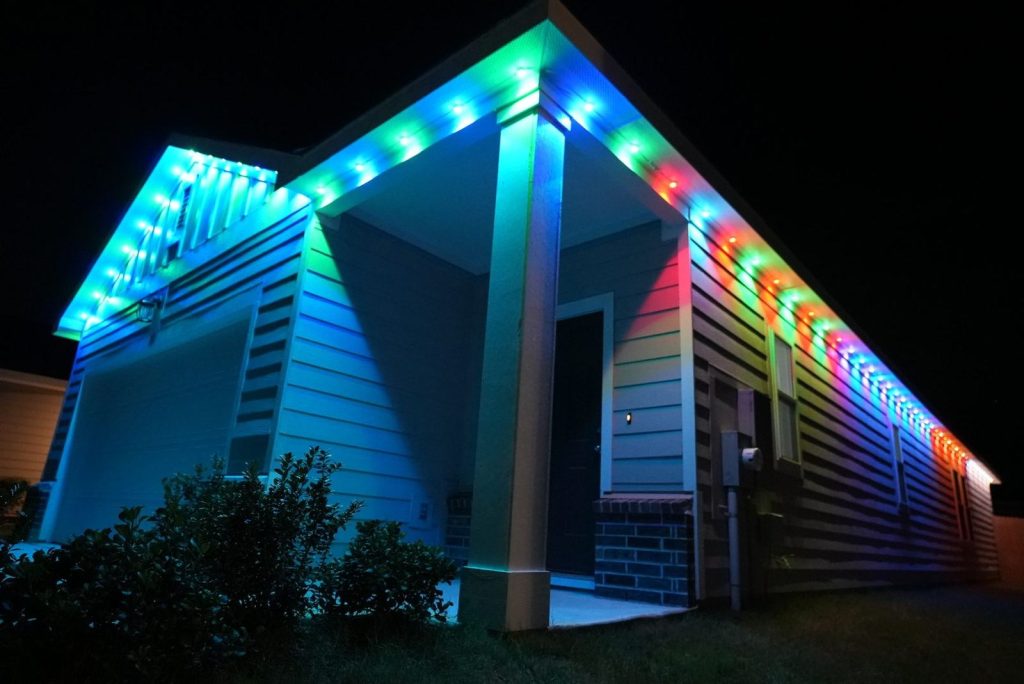 Modern home with permanent lights in rainbow colors along the roofline