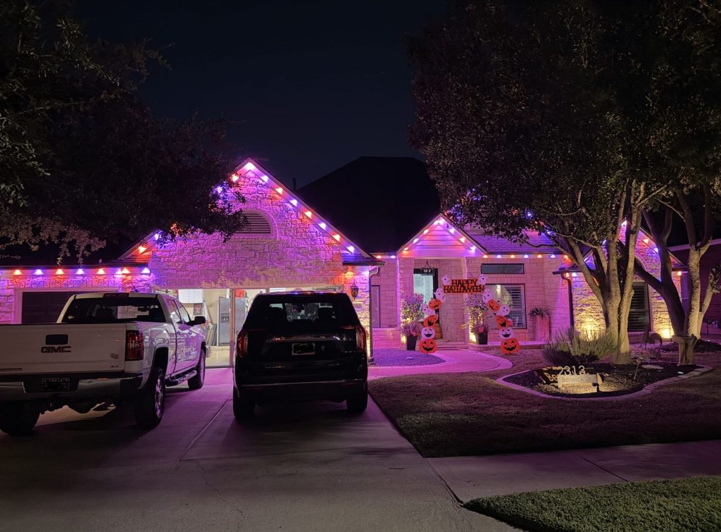 Single-story home with permanent lights in pink and purple