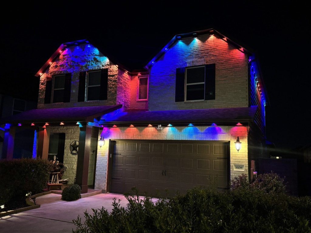 Two-story home with permanent lights in red, purple and blue