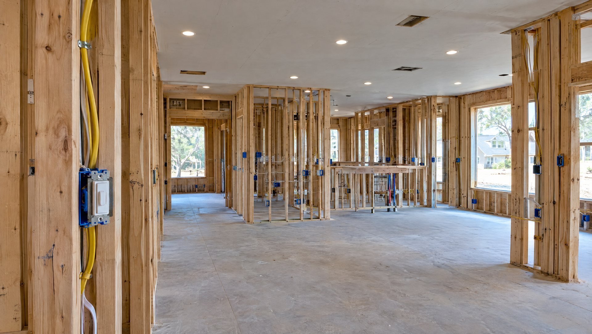 Home under construction with exposed wiring, electrical boxes and recessed LED ceiling lights