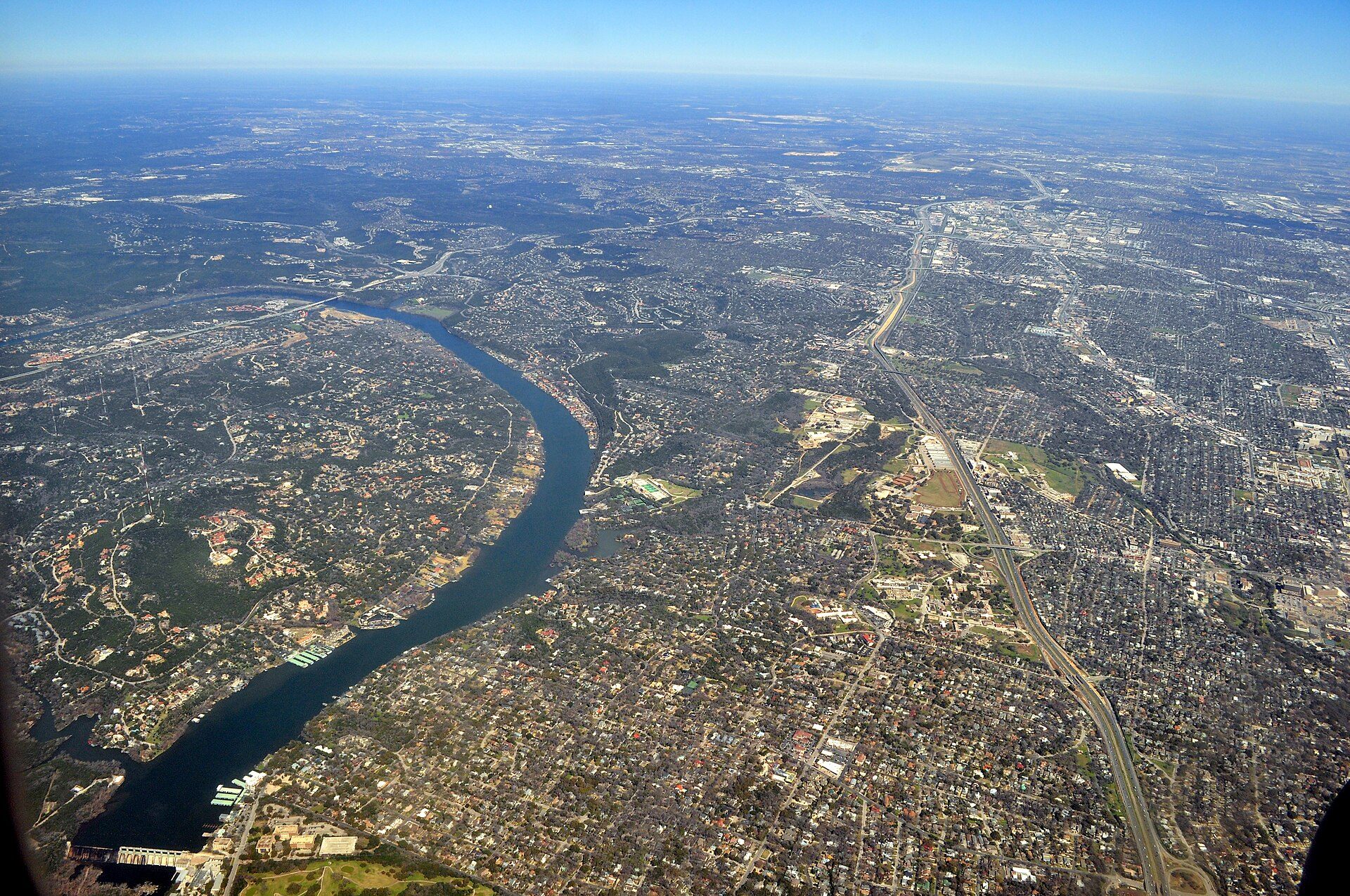 Aerial view of Lake Austin with West Lake Hills on the wooded hills to the west and Tarrytown in Austin to the east